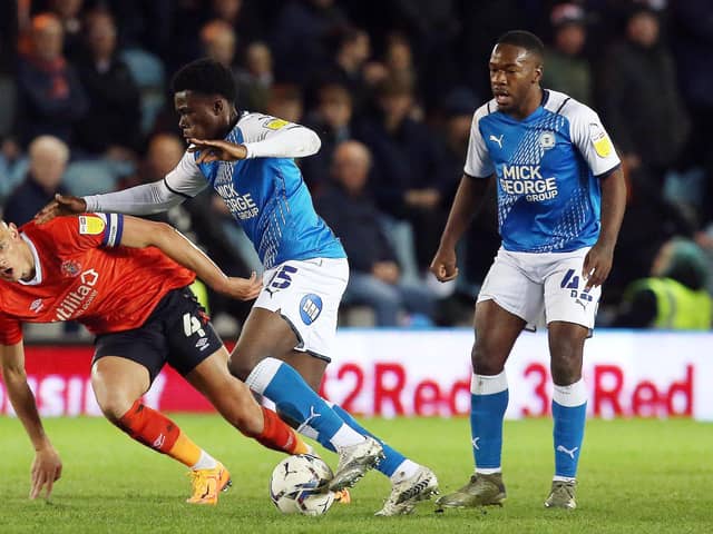 Kwame Poku of Peterborough United in action with Kal Naismith of Luton Town. Photo: Joe Dent/theposh.com.