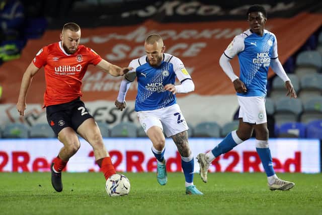 Joe Ward of Peterborough United in action with Allan Campbell of Luton Town. Photo: Joe Dent/theposh.com.