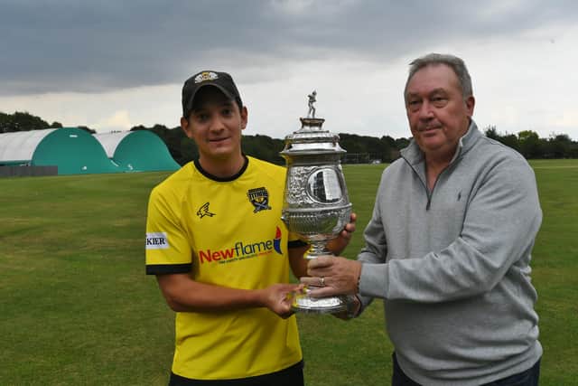 Peterborough Town skipper David Clarke receives the 2021 Northants Premier Division trophy.