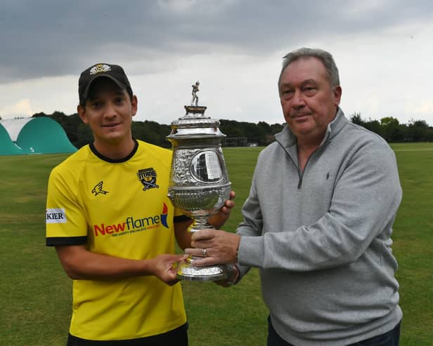 Peterborough Town skipper David Clarke receives the 2021 Northants Premier Division trophy.