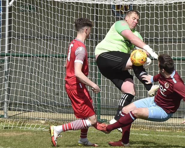 Stlton United goalkeeper Dave Beeny in the thick of the action against Deeping Rangers Reserves. Photo: David Lowndes.