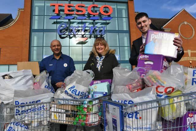 Supplies for Ukraine donated by Tesco, Serpentine Green  -   Tesco Hampton  store manager Sam Jones with Tesco community champion Ejaz Moghul and fundraiser Jackie Fletcher-Keighley EMN-220904-155959009
