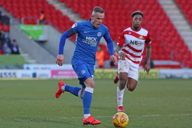 Mallik Wilks (right) in action for Doncaster against Posh in 2019.