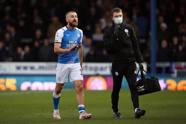 Dan Butler of Peterborough United leaves the pitch after picking up his injury in the home win over Millwall.