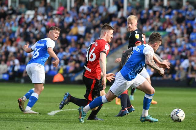 Harrison Burrows (left) plays Sammie Szmodics through for his goal for Posh against Blackburn. Photo: David Lowndes.