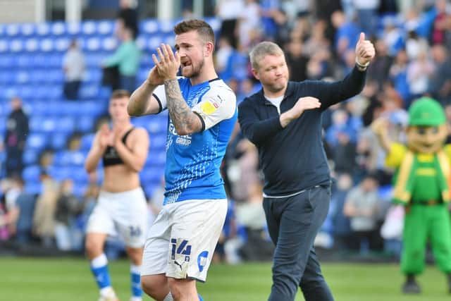 Jack Marriott and Grant McCann acknowledge the fans after the win over Blackburn. Photo: David Lowndes.