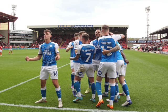 Harrison Burrows leads the celebrations after Posh score a second goal at Barnsley. Photo: Joe Dent/theposh.com.
