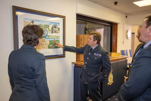 Warrant Officer Lowe explains some of the historical details in the painting.