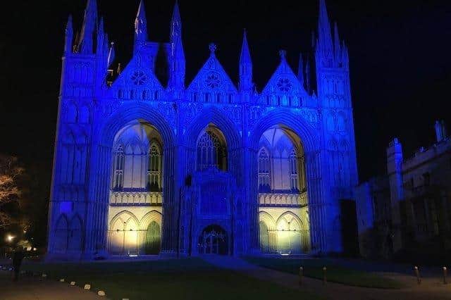Peterborough Cathedral lit up in the colours of the Ukrainian flag. The cathedral will host a meeting for people interested in signing up to a scheme to provide a home for refugees from Ukraine