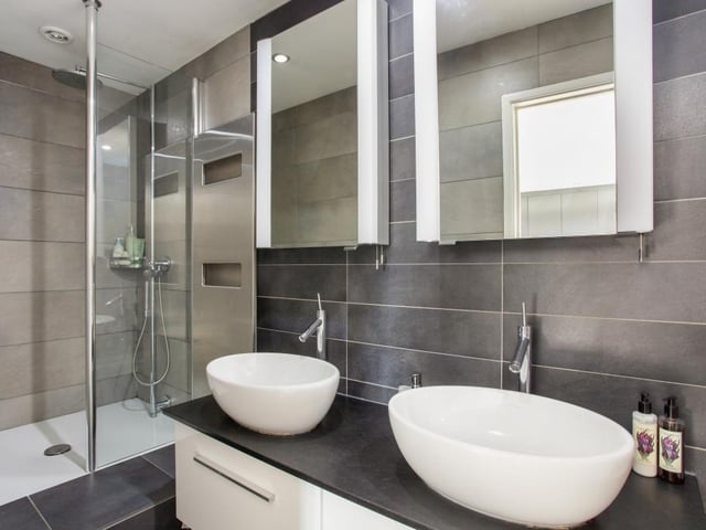 The bathroom has had sleek and modern bathroom upgrades.