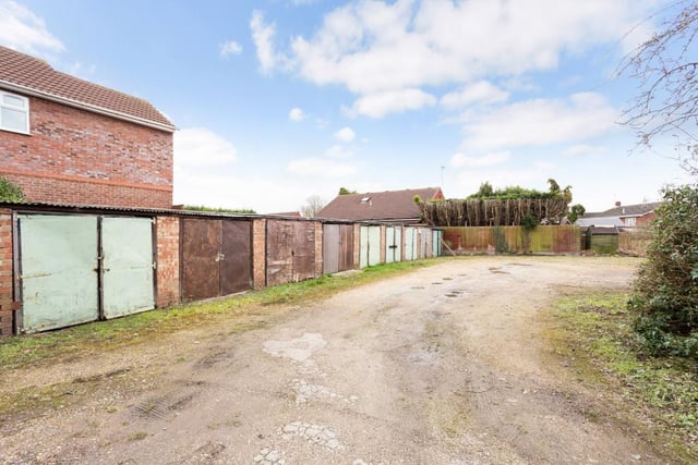 The property sits on 0.49 of an acre with outbuildings and 13 garages.