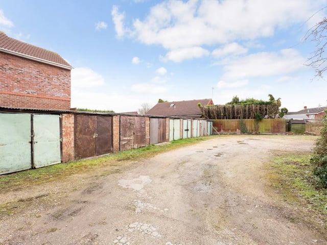 The property sits on 0.49 of an acre with outbuildings and 13 garages.