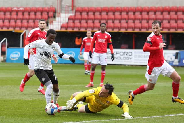 Siriki Dembele of Peterborough United takes the ball around Lee Camp of Swindon Town to score the opening goal of the game. Photo: Joe Dent/theposh.com
