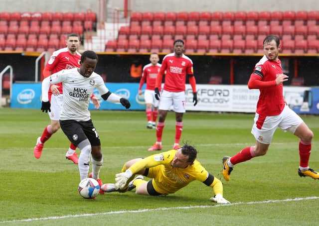 Siriki Dembele of Peterborough United takes the ball around Lee Camp of Swindon Town to score the opening goal of the game. Photo: Joe Dent/theposh.com
