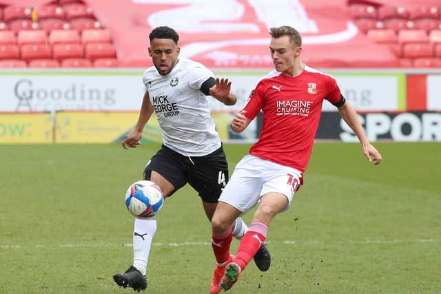 Nathan Thompson Peterborough United in action with Scott Twine of Swindon Town. Photo: Joe Dent/theposh.com.