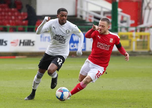 Reece Brown of Peterborough United in action with Jack Payne of Swindon Town. Photo: Joe Dent/theposh.com.