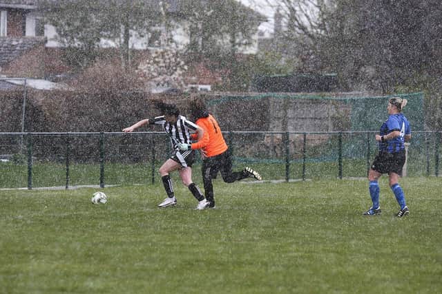 Jess Driscoll scores in the snow for Peterborough Northern Star Ladies against Whittlesey Athletic. Photo: Tim Symonds.