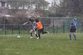 Jess Driscoll scores in the snow for Peterborough Northern Star Ladies against Whittlesey Athletic. Photo: Tim Symonds.