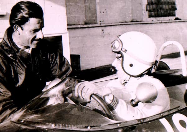 Formula 1 world champion Graham Hill shares a few racing tips at the Folkingham test site back in the sixties. EMN-210416-151006001