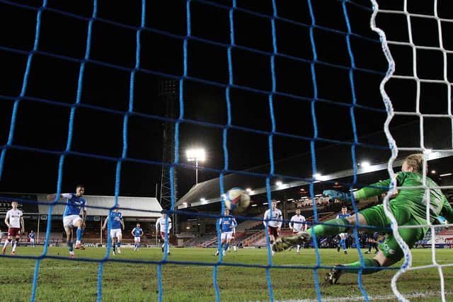 Jonson Clarke-Harris of Peterborough United scores from the penalty spot past Cobblers 'keeper Jon Mitchell. Photo: Joe Dent/theposh.com.