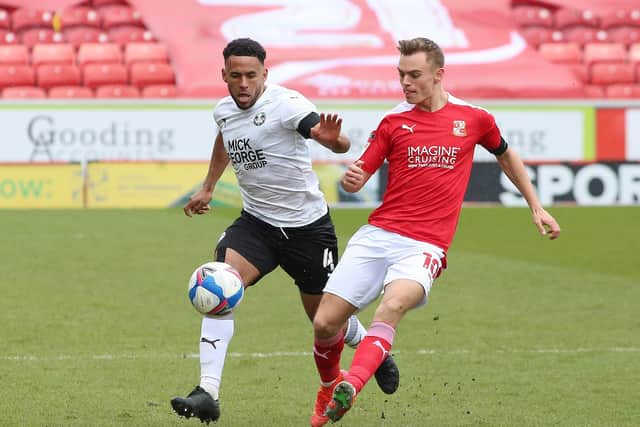 Scott Twine (red) in action against Posh earlier this month. Photo: Joe Dent/theposh.com.