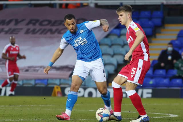 Jonson Clarke-Harris of Peterborough United in action with Jack Tucker of Gillingham. Photo: Joe Dentt/theposh.com.