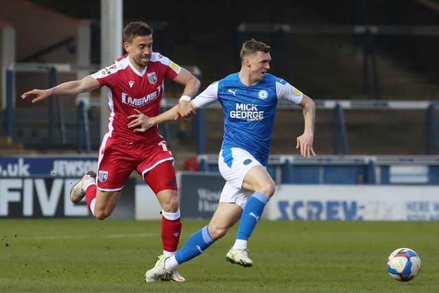 Posh midfielder Jack Taylor of Peterborough United gets away from Oliver Lee of Gillingham. Photo: Joe Dent/theposh.com