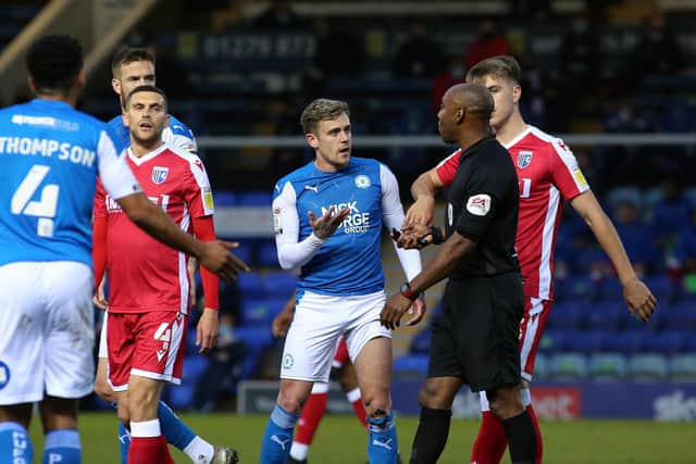 Sammie Szmodics of Peterborough United appeals to referee Sam Allison for a foul during the game against Gillingham. Photo: Joe Dent/theposh.com.