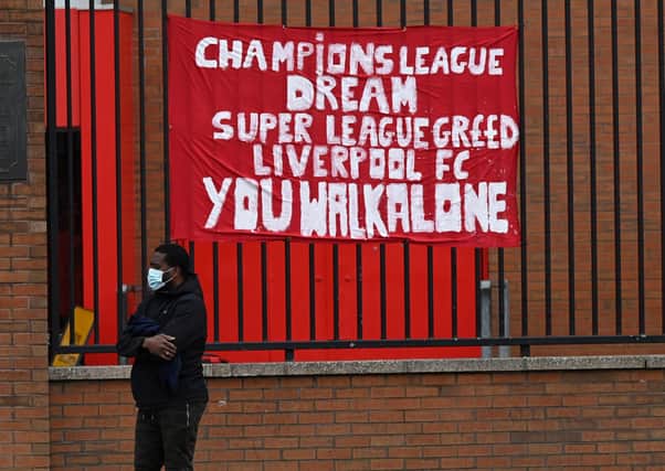 Banners critical of the European Super League project  hang from the railings of Anfield stadium, home of English Premier League football club Liverpool. (Photo by PAUL ELLIS/AFP via Getty Images)