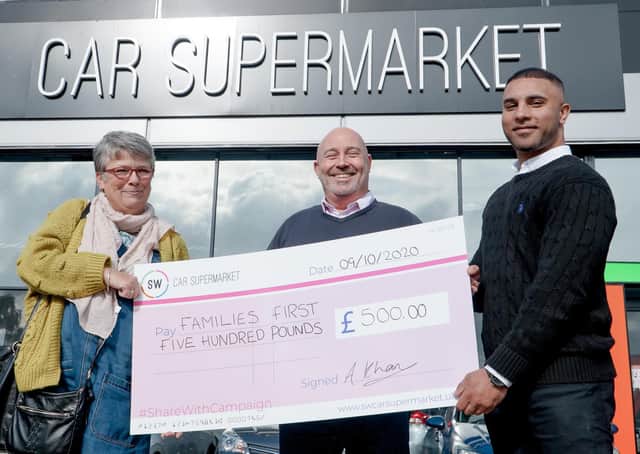 Cherry Lester from Families First Peterborough receives a cheque from SW Car Supermarket.
