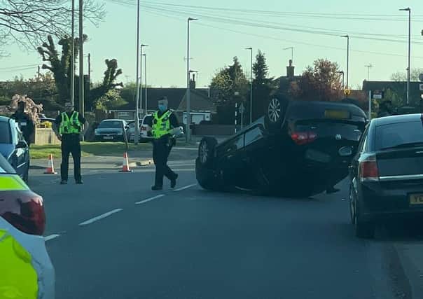 An overturned car on Welland Road yesterday.
