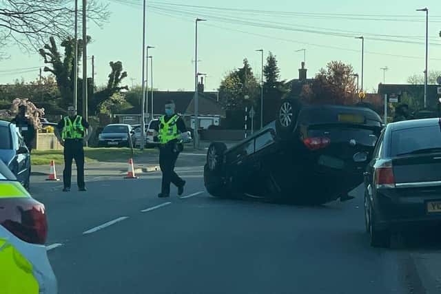 An overturned car on Welland Road yesterday.