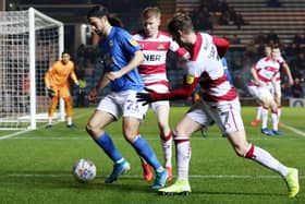 George Boyd in action for Posh with Kieran Sadlier (right) of Doncaster at London Road last season.