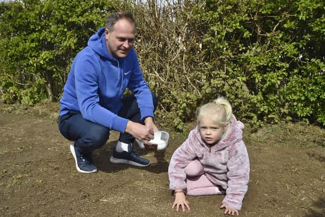 Seeding a community area at Sugar Way, Woodston are Gavin and Jessica Slater.