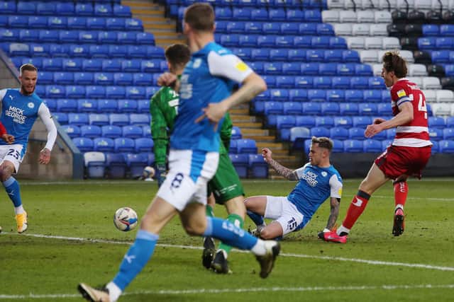 Sammie Szmodics of Peterborough United scores the second goal of the game against Doncaster Rovers. Photo: Joe Dent/theposh.com.