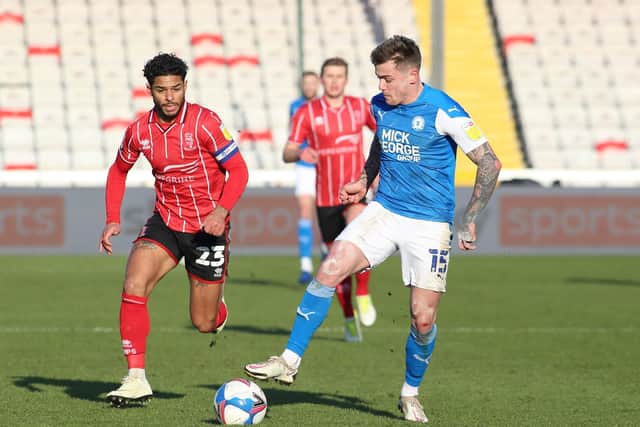 Sammie Szmodics of Peterborough United in action with Liam Bridcutt of Lincoln City. Photo: Joe Dent/theposh.com.