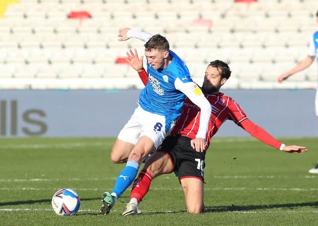 Jack Taylor of Peterborough United is tackled by Jorge Grant of Lincoln City. Photo: Joe Dent/theposh.com.