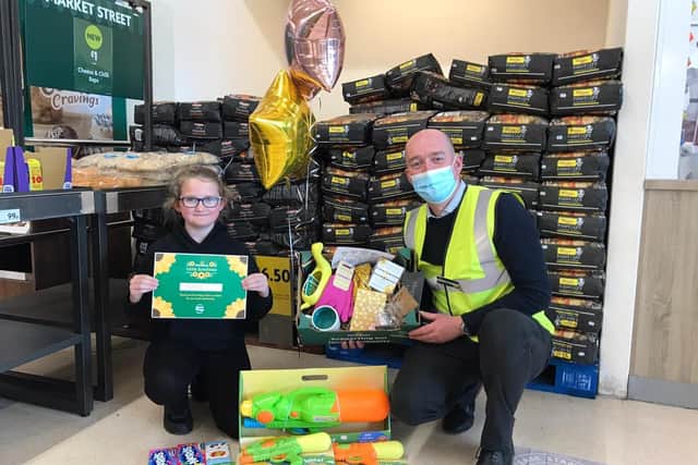 Megan Butler, 11, and Morrisons Store Manager Ben Daley. EMN-210430-155549001