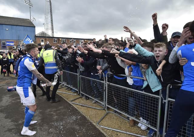 Posh players, staff and fans celebrate outside the Weston Homes Stadium after promotion to the Championship was clinched in dramatic style. Picture: David Lowndes.