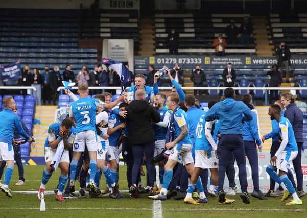 Posh players celebrate promotion after the draw with Lincoln. Photo: Joe Dent/theposh.com.