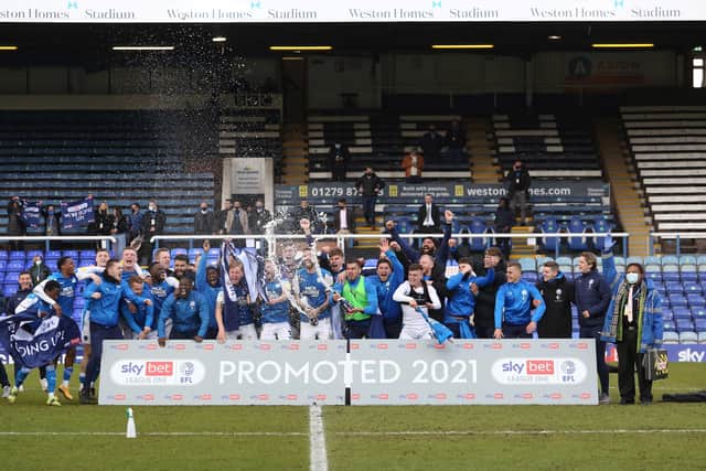 Posh skipper Mark Beevers (middle with bottle) leads the celebrations after promotion to the Championship was secured. Photo: Joe Dent/theposh.com.