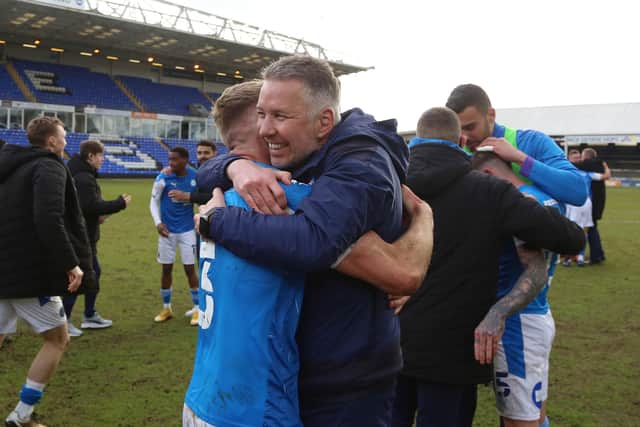 Peterborough United Manager Darren Ferguson celebrates winning promotion with Dan Butler. Photo: Joe Dent/theposh.com.