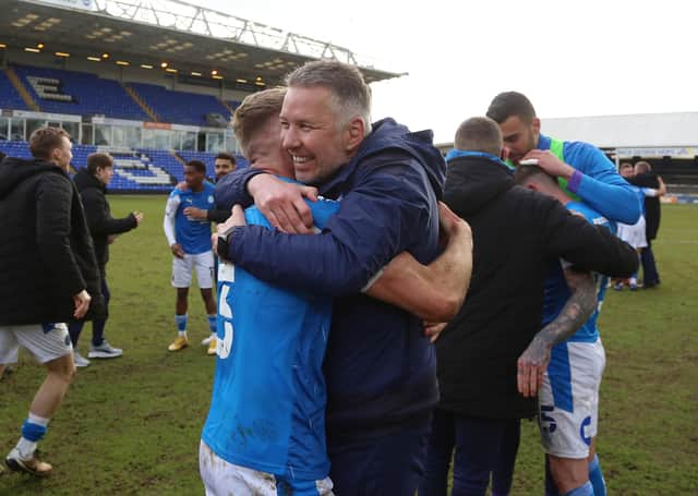 Peterborough United Manager Darren Ferguson celebrates winning promotion with Dan Butler. Photo: Joe Dent/theposh.com.