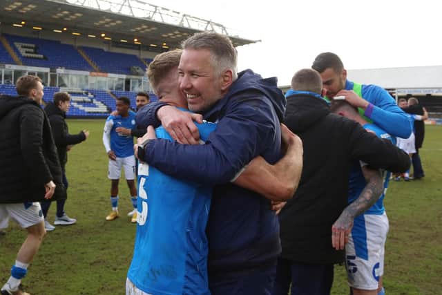 Peterborough United Manager Darren Ferguson celebrates winning promotion with Dan Butler. Photo: Joe Dent/theposh.com.