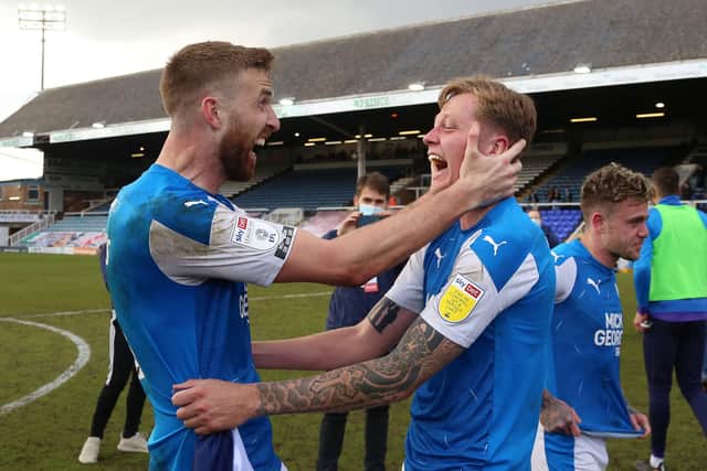 Mark Beevers and Frankie Kent of Peterborough United celebrate winning promotion at full-time. Photo: Joe Dent/theposh.com.