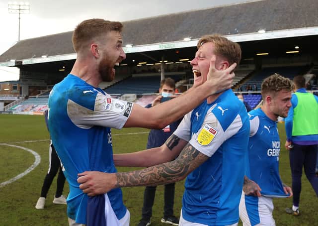 Mark Beevers and Frankie Kent of Peterborough United celebrate winning promotion at full-time. Photo: Joe Dent/theposh.com.