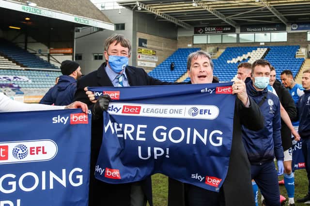 Posh co-owners Dr Jason Neale (left) and Stewart 'Randy' Thompson proudly hold the traditional promotion banner.