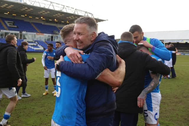 Peterborough United Manager Darren Ferguson celebrates winning promotion with Dan Butler. Photo: Joe Dent/theposh.com.