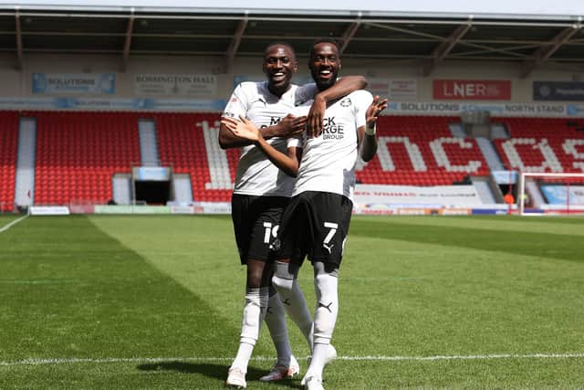 Mo Eisa (right) and Idris Kanu celebrate the former's goal for Posh at Doncaster. Photo: Joe Dent/theposh.com.
