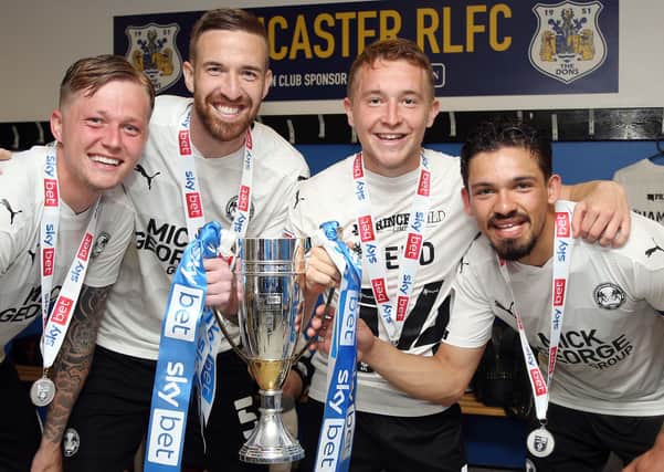 (from left) Frankie Kent, Mark Beevers, Louis Reed and Niall Mason with the League One runners-up trophy and their individual medals.